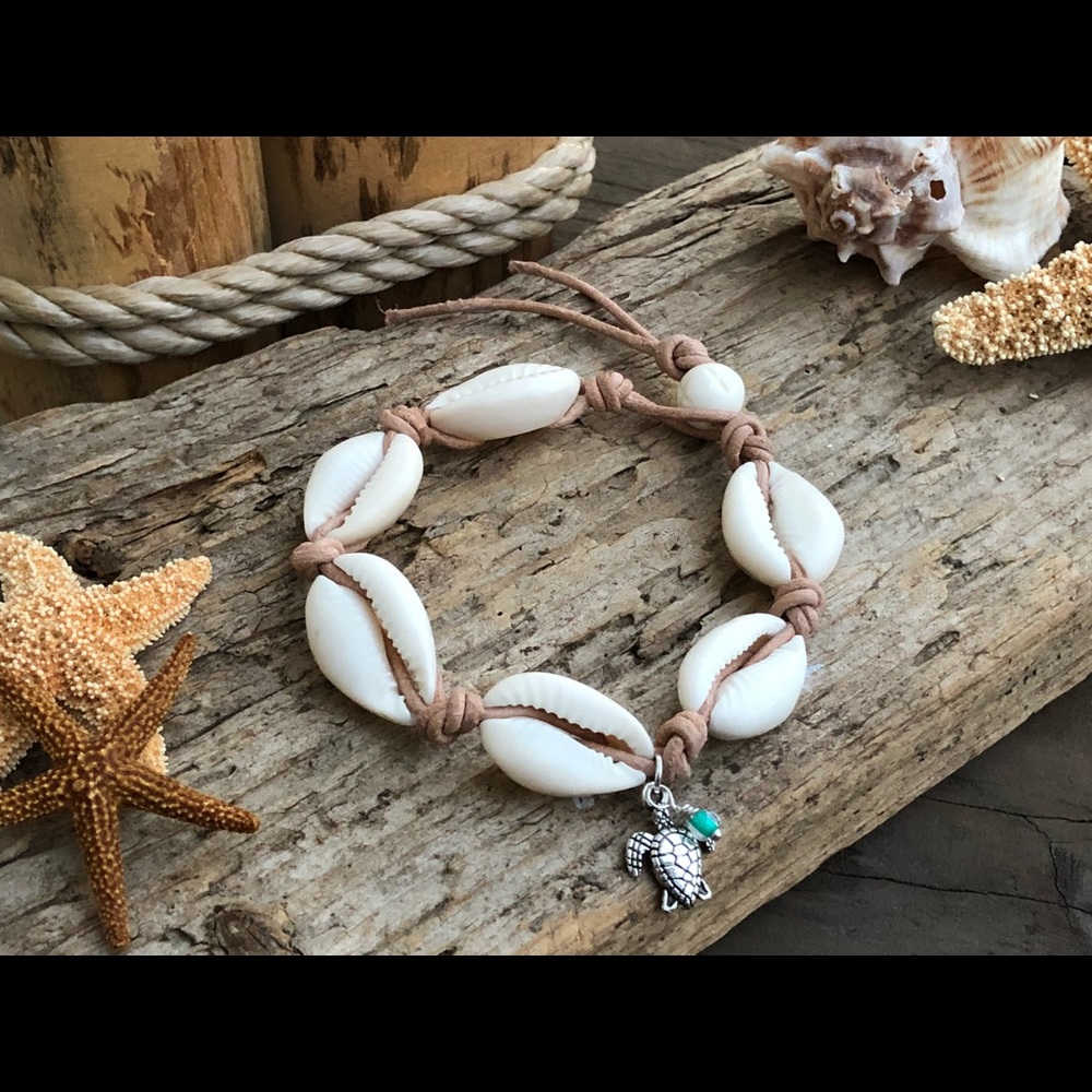 All natural cowrie shell bracelet with Bali charm